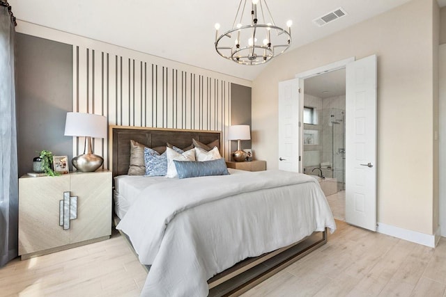 bedroom featuring visible vents, baseboards, light wood-type flooring, a chandelier, and vaulted ceiling