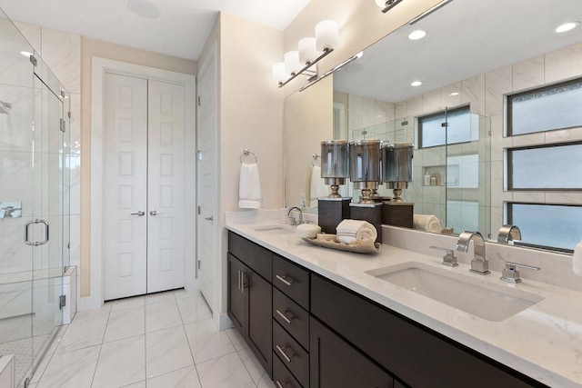 full bathroom featuring a sink, a shower stall, double vanity, and recessed lighting