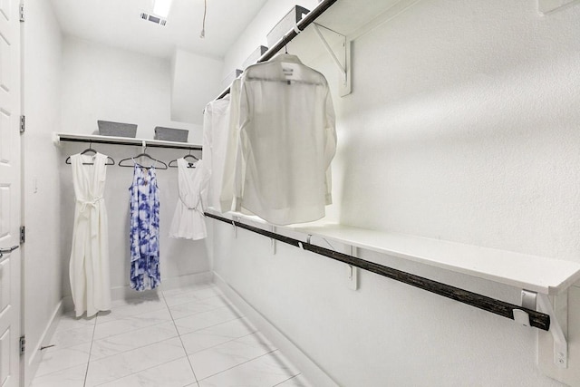 spacious closet with visible vents and marble finish floor