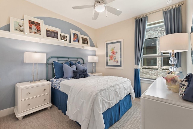 bedroom featuring baseboards, a ceiling fan, and light carpet