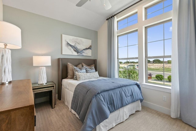 bedroom featuring ceiling fan, baseboards, carpet, and lofted ceiling