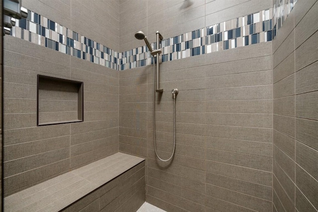 bathroom with a tile shower