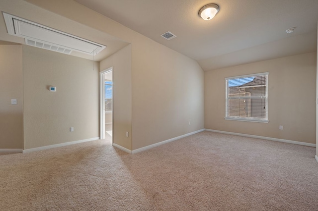 spare room with visible vents, baseboards, and light colored carpet