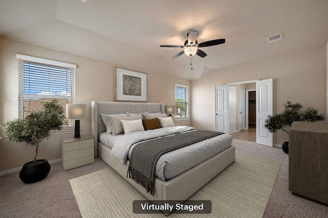 bedroom with visible vents, baseboards, vaulted ceiling, and light carpet
