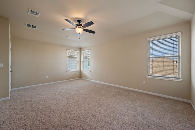 spare room with ceiling fan, carpet, and visible vents