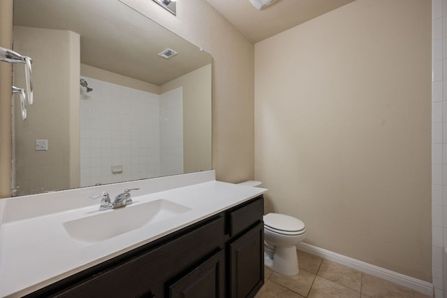 bathroom with tiled shower, vanity, tile patterned flooring, visible vents, and toilet