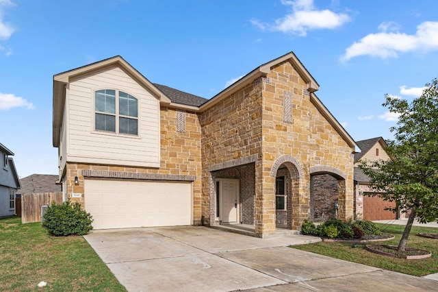 view of front facade with an attached garage, fence, stone siding, and driveway