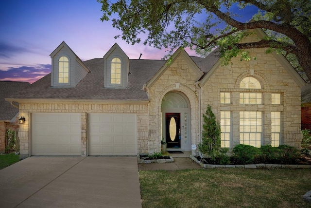 8909 Beatty Ct, Austin, TX 78749 - view of front of property featuring concrete driveway, a shingled roof, an attached garage, stone siding, and a front yard