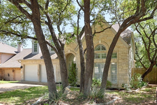 8909 Beatty Ct, Austin, TX 78749 - view of front of property with stone siding, roof with shingles, concrete driveway, and an attached garage
