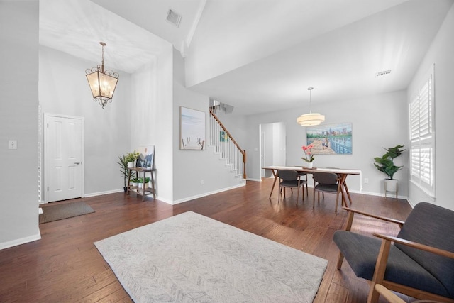 8909 Beatty Ct, Austin, TX 78749 - living area featuring stairway, wood finished floors, baseboards, a towering ceiling, and a chandelier