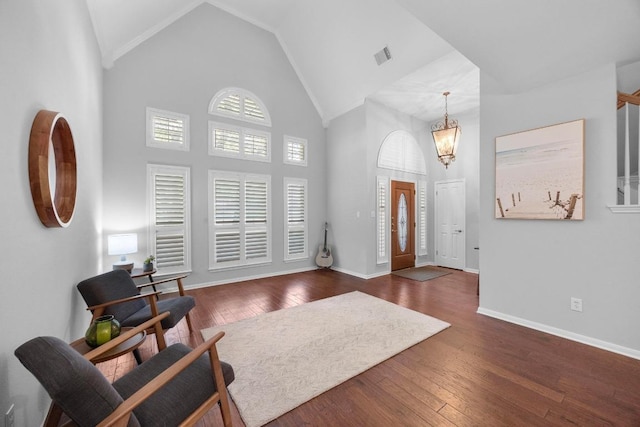 8909 Beatty Ct, Austin, TX 78749 - foyer with high vaulted ceiling, dark wood-style floors, a chandelier, and baseboards