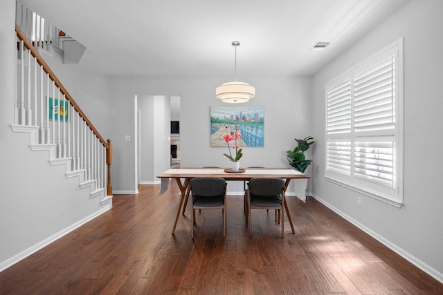 8909 Beatty Ct, Austin, TX 78749 - dining space with dark wood-style floors, stairs, and baseboards