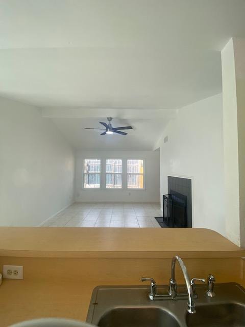 12318 Marogot Run, Austin, TX 78758 - kitchen featuring lofted ceiling, ceiling fan, light tile patterned floors, and a fireplace with flush hearth