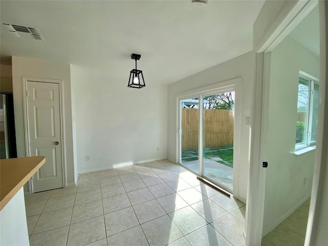 12318 Marogot Run, Austin, TX 78758 - unfurnished dining area featuring light tile patterned floors and baseboards