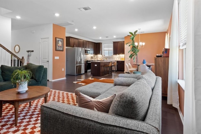 6809 Ellsworth Walk, Austin, TX 78724 - living room featuring dark wood-type flooring, a chandelier, baseboards, recessed lighting, and stairs