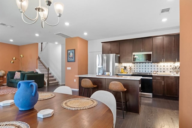 6809 Ellsworth Walk, Austin, TX 78724 - dining room featuring stairs, dark wood finished floors, a chandelier, and recessed lighting
