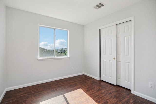 339 Liberty St, Hutto, TX 78634 - unfurnished bedroom with dark wood-style floors and a closet