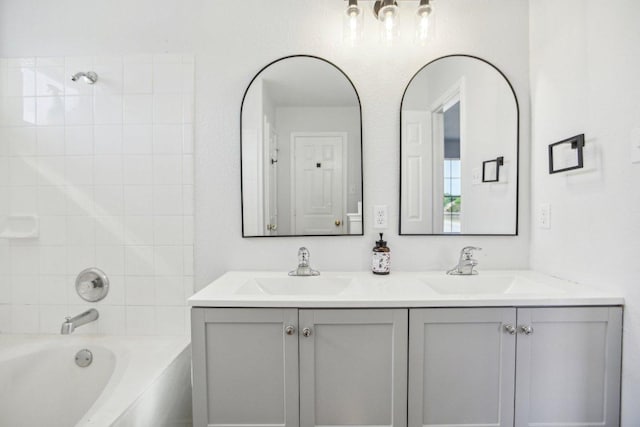 339 Liberty St, Hutto, TX 78634 - bathroom with double vanity and bathing tub / shower combination