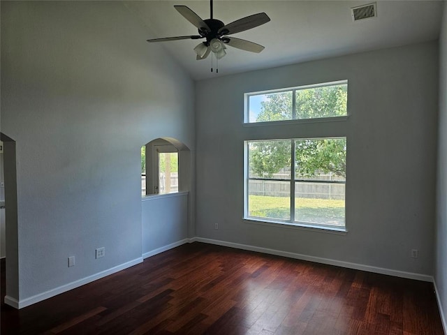 339 Liberty St, Hutto, TX 78634 - unfurnished room with high vaulted ceiling, dark wood-style flooring, a ceiling fan, and arched walkways