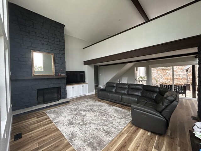 438 Eagle, Lakeway, TX 78734 - living room with a fireplace, wood finished floors, baseboards, and high vaulted ceiling