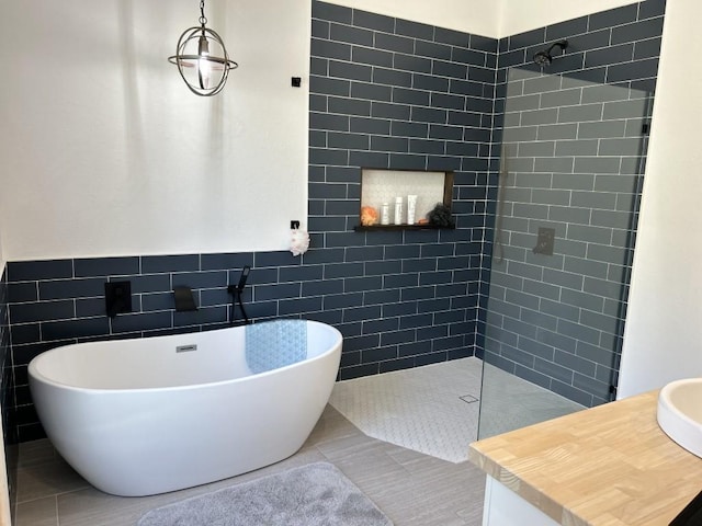 438 Eagle, Lakeway, TX 78734 - bathroom featuring tile walls, a tile shower, and a soaking tub