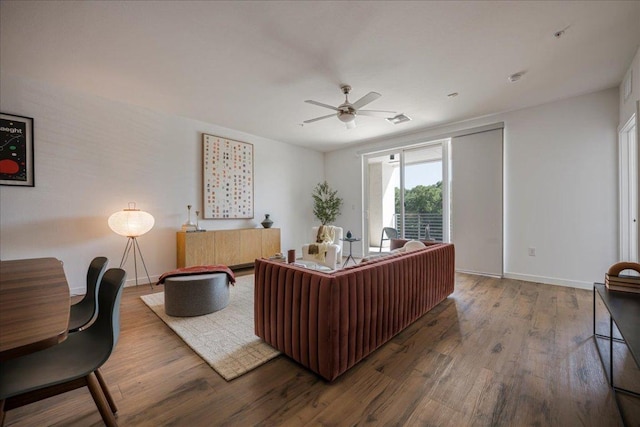 office space featuring wood finished floors, ceiling fan, and baseboards