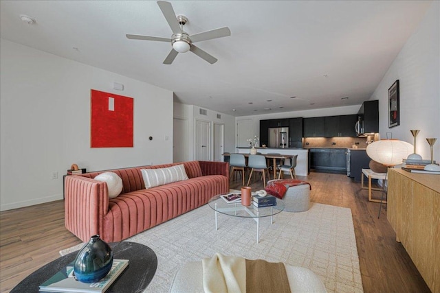 4801 Springdale Rd Unit 1107, Austin, TX 78723 - living room featuring wood finished floors and a ceiling fan