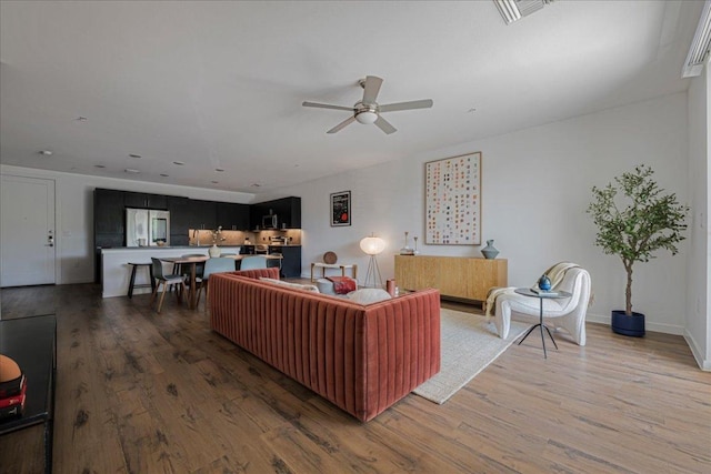4801 Springdale Rd Unit 1107, Austin, TX 78723 - living area with ceiling fan and light wood finished floors