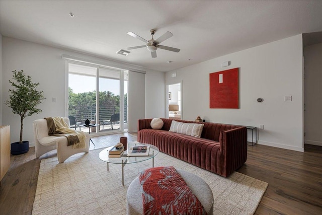 living room with visible vents, ceiling fan, baseboards, and wood finished floors