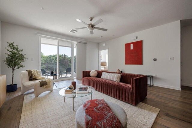4801 Springdale Rd Unit 1107, Austin, TX 78723 - living room featuring wood finished floors, a ceiling fan, and baseboards