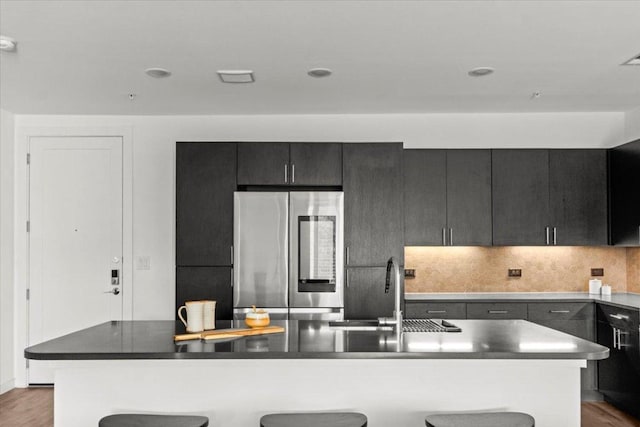 4801 Springdale Rd Unit 1107, Austin, TX 78723 - kitchen with smart refrigerator, a sink, a kitchen bar, tasteful backsplash, and recessed lighting