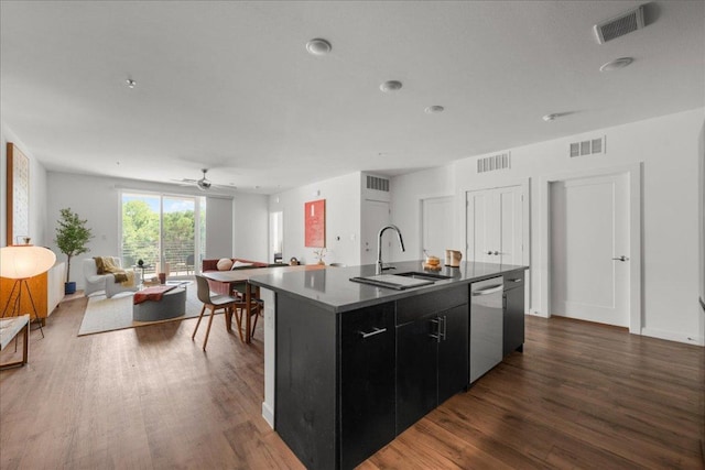 kitchen with a sink, visible vents, dishwasher, and dark cabinets