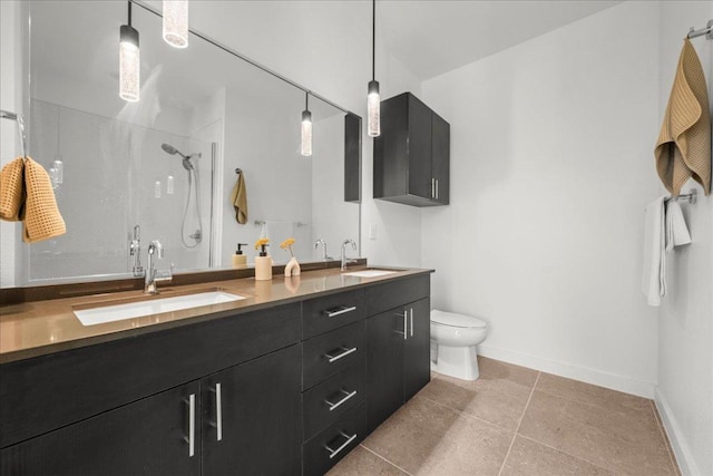 4801 Springdale Rd Unit 1107, Austin, TX 78723 - bathroom featuring double vanity, a stall shower, toilet, and baseboards
