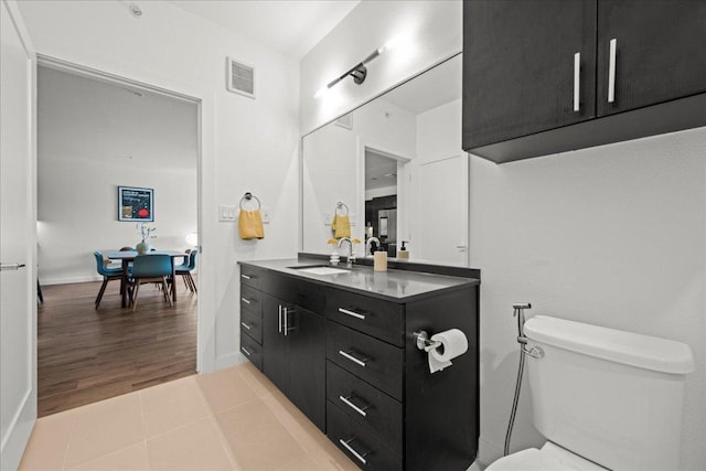 4801 Springdale Rd Unit 1107, Austin, TX 78723 - bathroom with vanity, toilet, tile patterned flooring, and baseboards