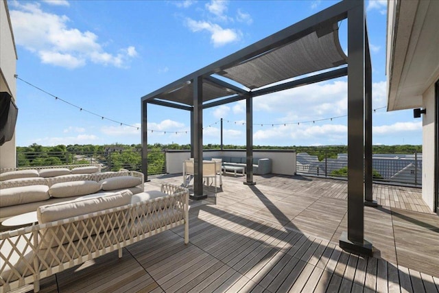 wooden terrace with an outdoor living space