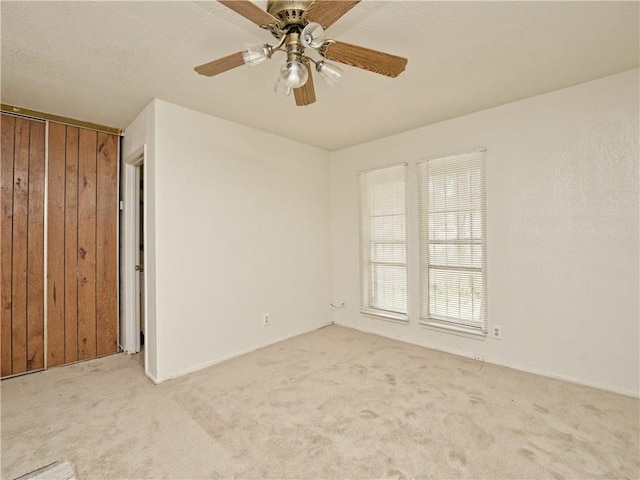 6916 Carwill Dr, Austin, TX 78724 - unfurnished bedroom featuring carpet, a ceiling fan, and wood walls