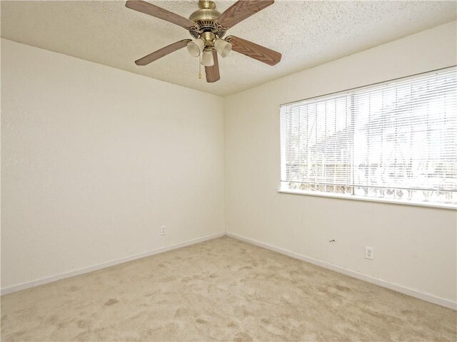 6916 Carwill Dr, Austin, TX 78724 - empty room with light carpet, baseboards, a textured ceiling, and ceiling fan