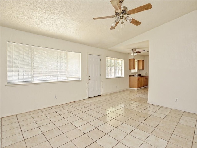 6916 Carwill Dr, Austin, TX 78724 - entrance foyer with vaulted ceiling, ceiling fan, and a textured ceiling