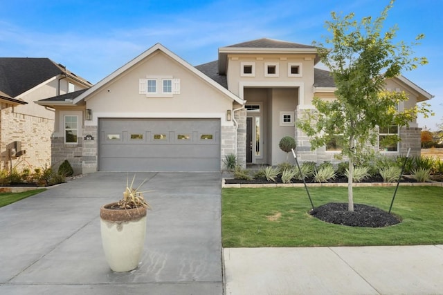 328 Ridgewell Loop, Georgetown, TX 78633 - view of front facade with driveway, stone siding, stucco siding, and a front lawn
