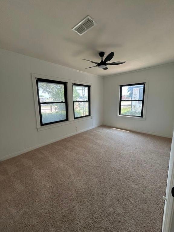 606 Springdale Rd, Austin, TX 78702 - carpeted empty room featuring a ceiling fan and baseboards