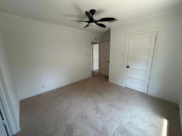 606 Springdale Rd, Austin, TX 78702 - unfurnished bedroom featuring carpet, ornamental molding, and a ceiling fan