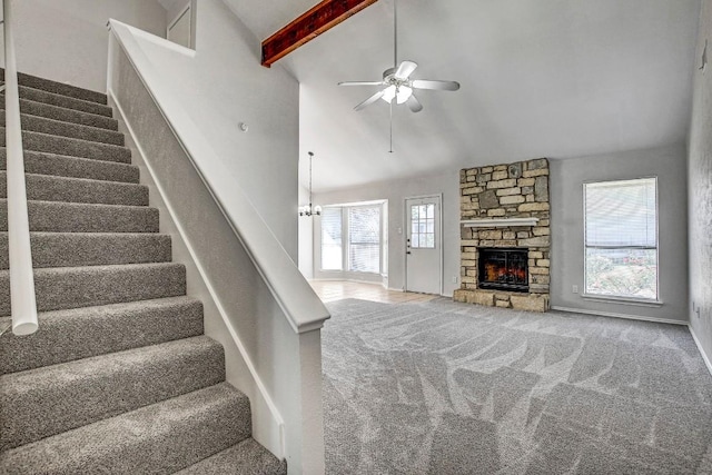2109 Delvin Ln, Austin, TX 78728 - stairway with a ceiling fan, a fireplace, beamed ceiling, carpet flooring, and high vaulted ceiling