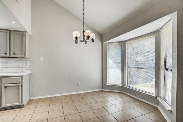 2109 Delvin Ln, Austin, TX 78728 - unfurnished dining area with a chandelier, lofted ceiling, light tile patterned flooring, and baseboards