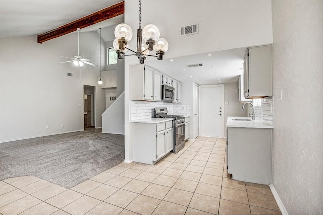 2109 Delvin Ln, Austin, TX 78728 - kitchen with appliances with stainless steel finishes, a sink, high vaulted ceiling, a ceiling fan, and light countertops