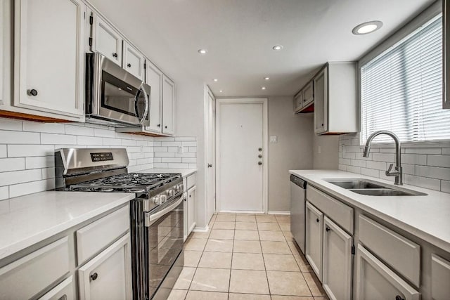 2109 Delvin Ln, Austin, TX 78728 - kitchen featuring stainless steel appliances, a sink, light countertops, tasteful backsplash, and recessed lighting