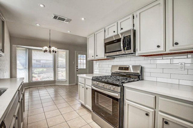 2109 Delvin Ln, Austin, TX 78728 - kitchen featuring stainless steel appliances, a chandelier, decorative backsplash, light countertops, and recessed lighting