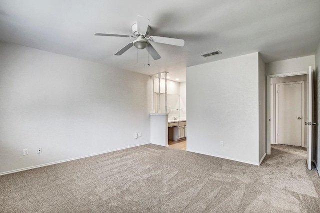 2109 Delvin Ln, Austin, TX 78728 - unfurnished bedroom with light carpet, baseboards, ensuite bathroom, and ceiling fan