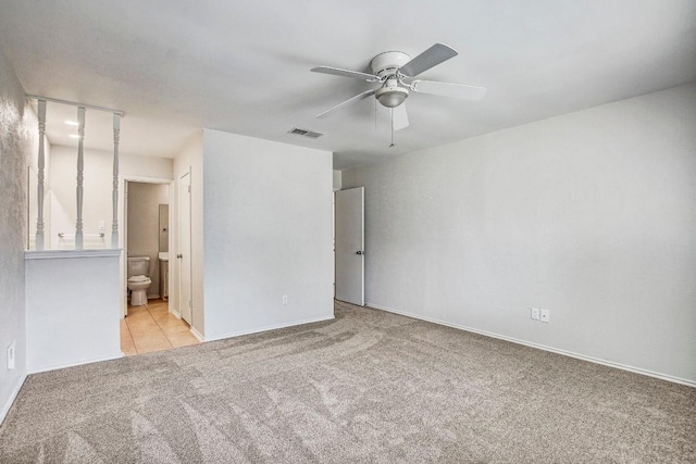 2109 Delvin Ln, Austin, TX 78728 - unfurnished bedroom featuring carpet, connected bathroom, baseboards, and a ceiling fan