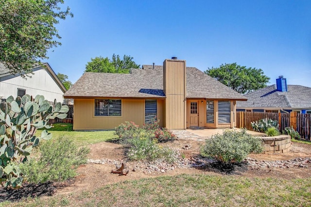 2109 Delvin Ln, Austin, TX 78728 - back of property with a patio, a chimney, and a shingled roof