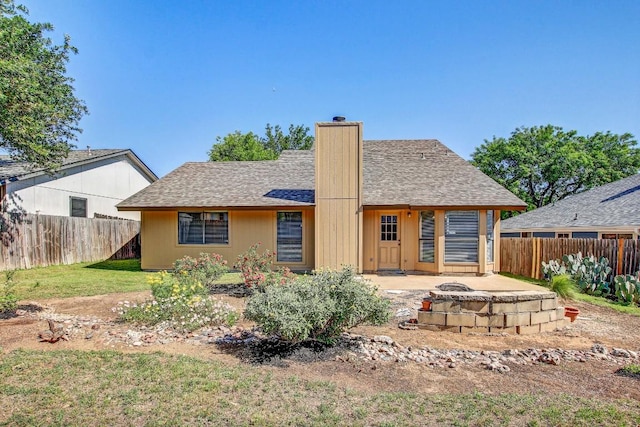2109 Delvin Ln, Austin, TX 78728 - rear view of property featuring a chimney, an outdoor fire pit, roof with shingles, and a patio
